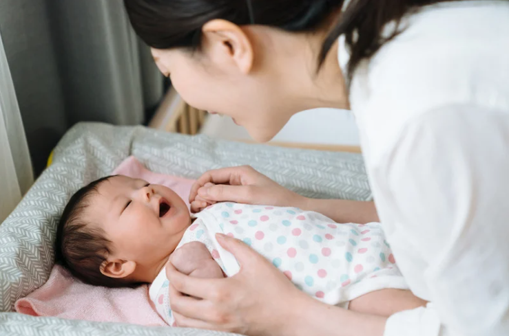 Asian woman talking to her baby