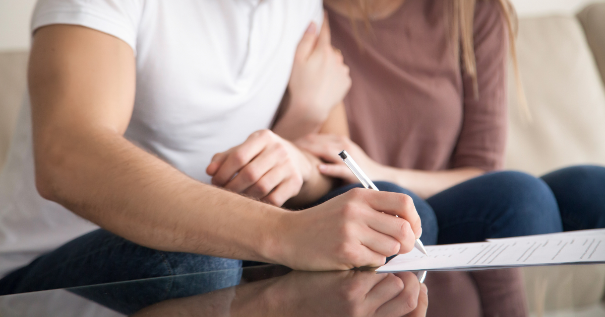 couple signing papers