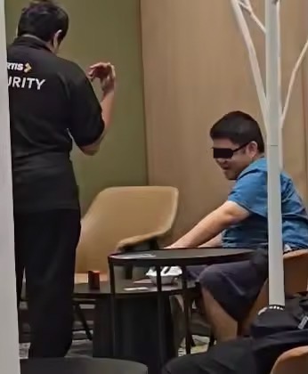 Durian-eating man escorted by security
