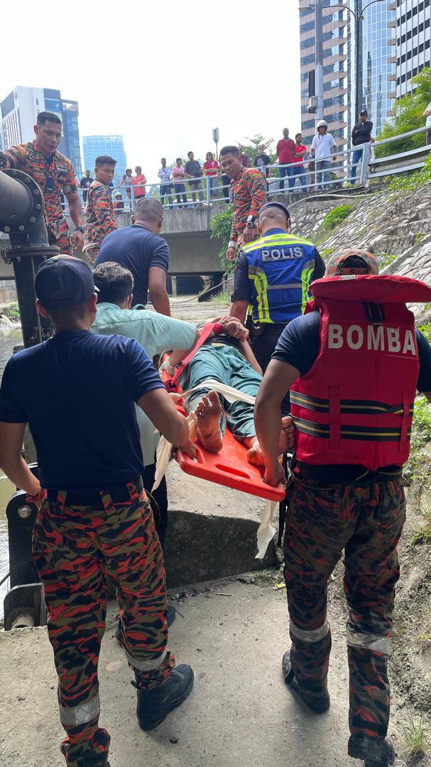 Firefighters carrying Myanmar woman to safety