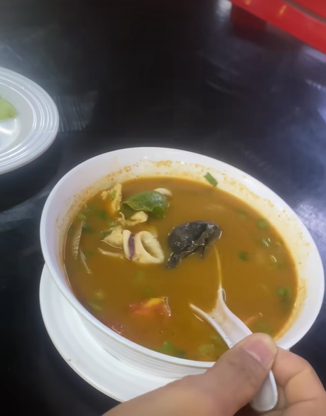 Frog inside tom yam soup