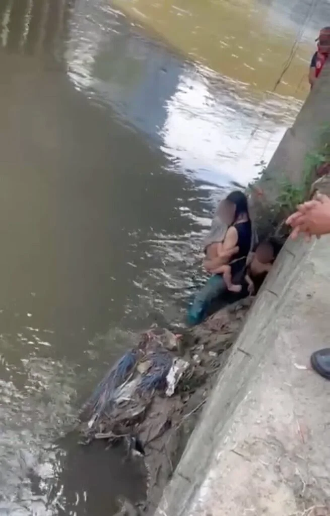 Myanmar woman stands near river in KL