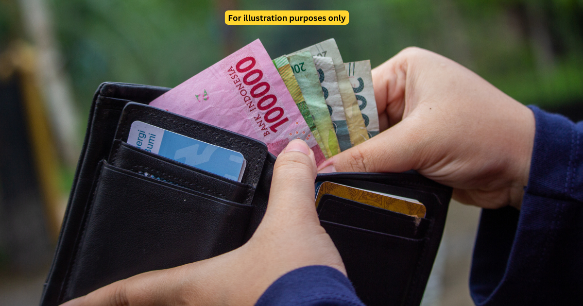 rupiah notes in wallet hand