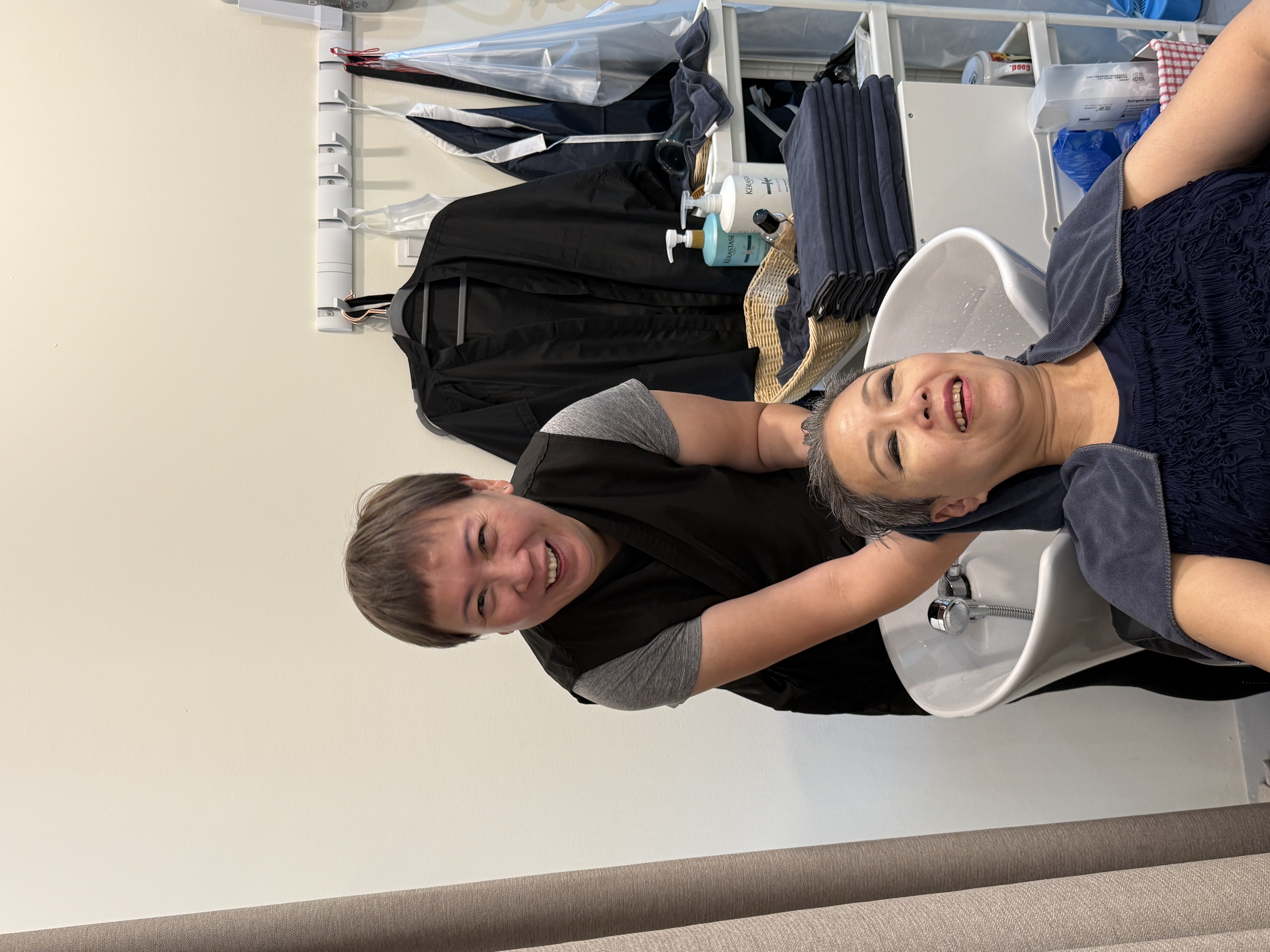Sam washing hair for customer
