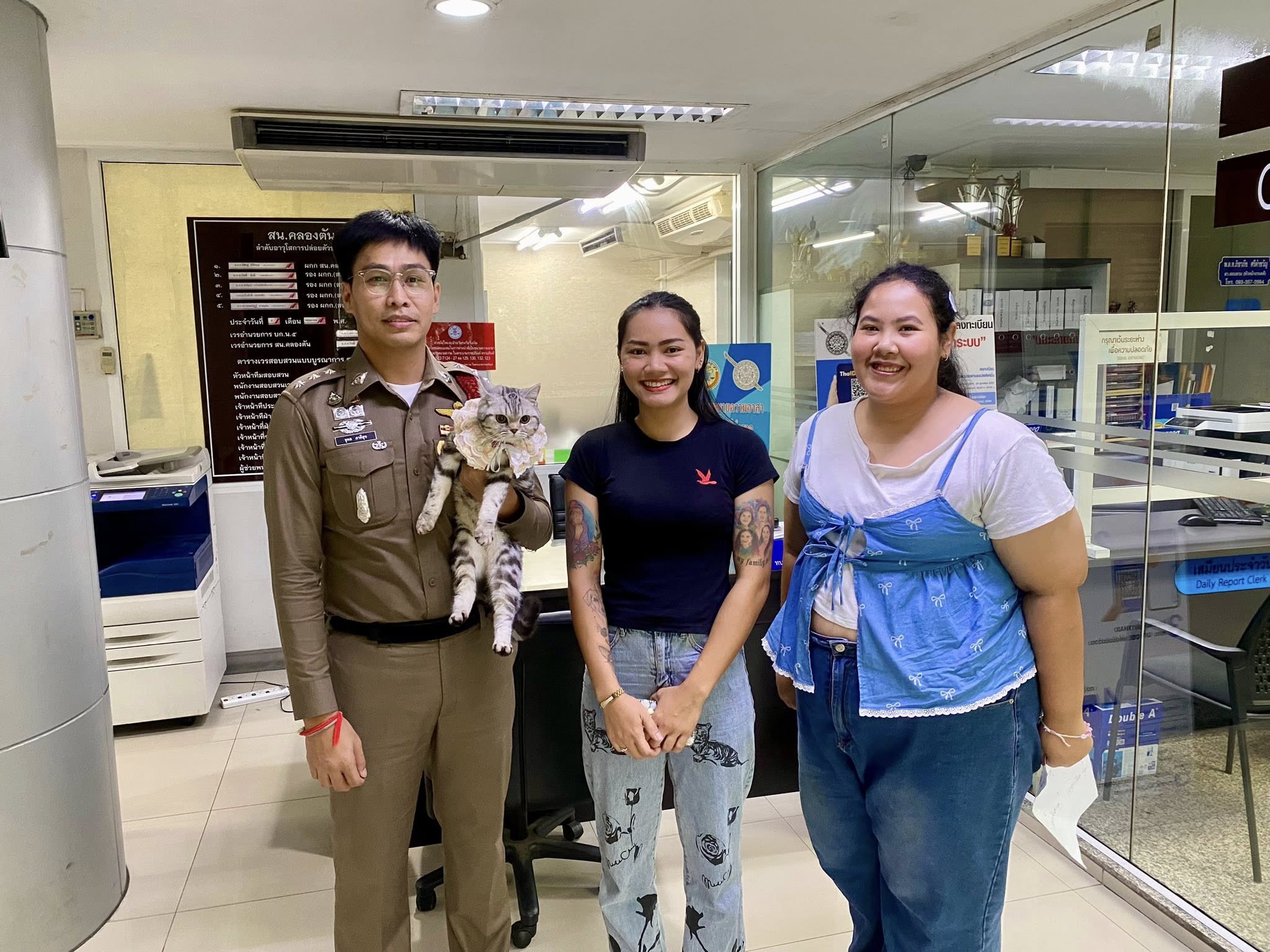 thai police with cat and its owners